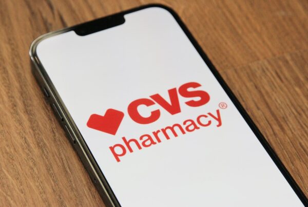 CVS Pharmacy logo on iPhone lying on a table.