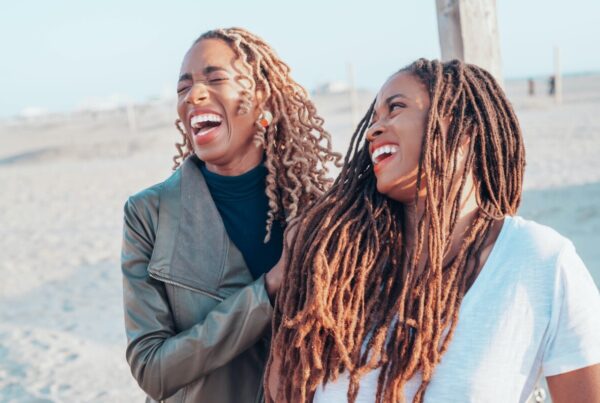 two Africa American women laughing in loving way | Understanding Stocks