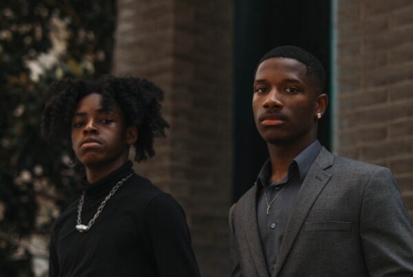 2 black young men standing outside