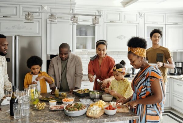 Black family in the kitchen making a meal.
