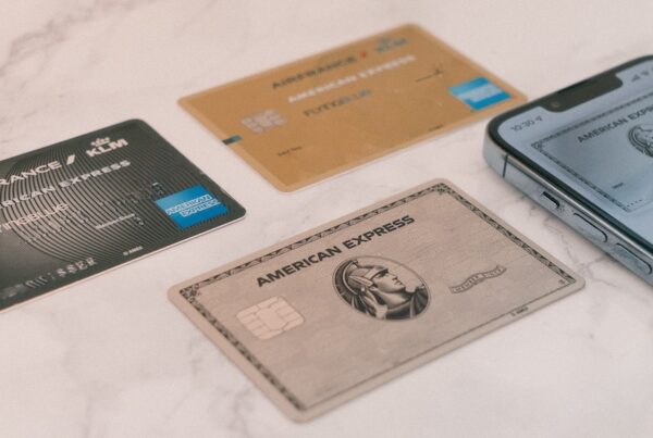 American Express credit cards on the counter with a smartphone.