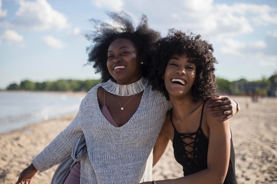 Two black women laughing at the beach - Wells Fargo’s Intuitive Investor
