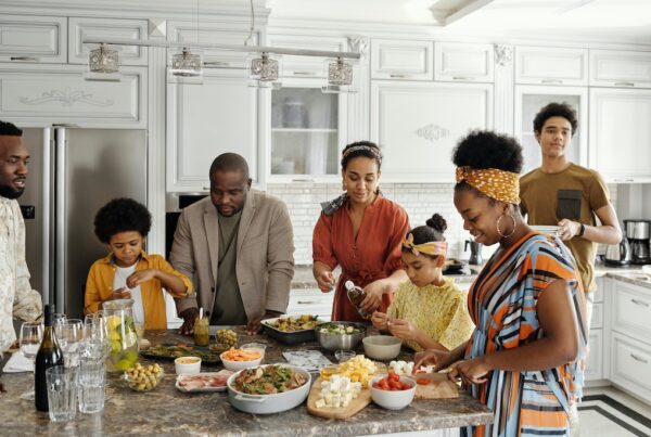 Black family making food in the kitchen.