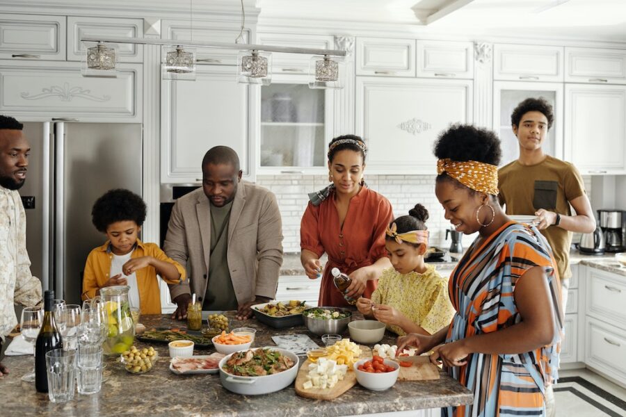 Black family making food in the kitchen.
